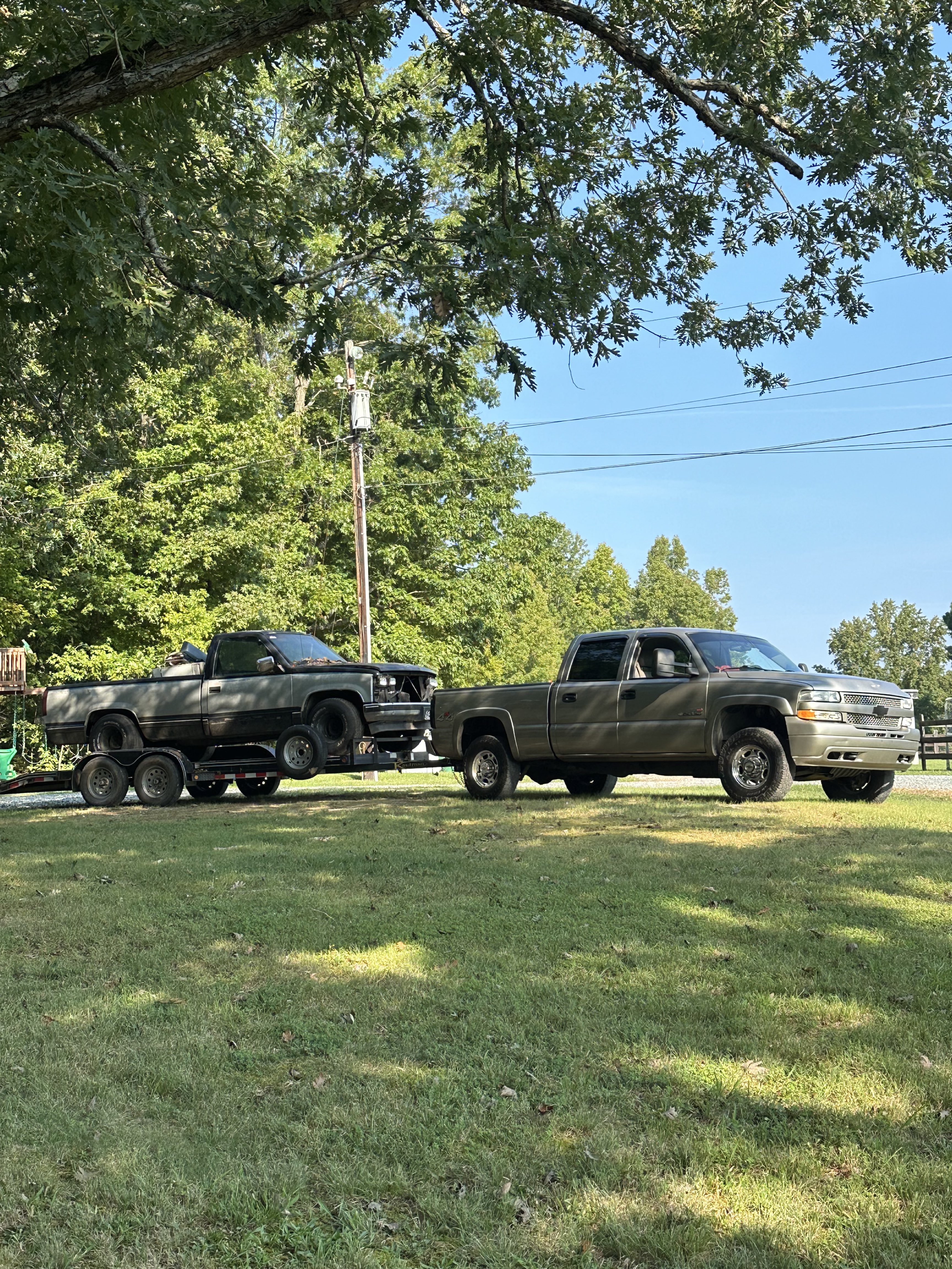 Truck hauling a car on a trailer