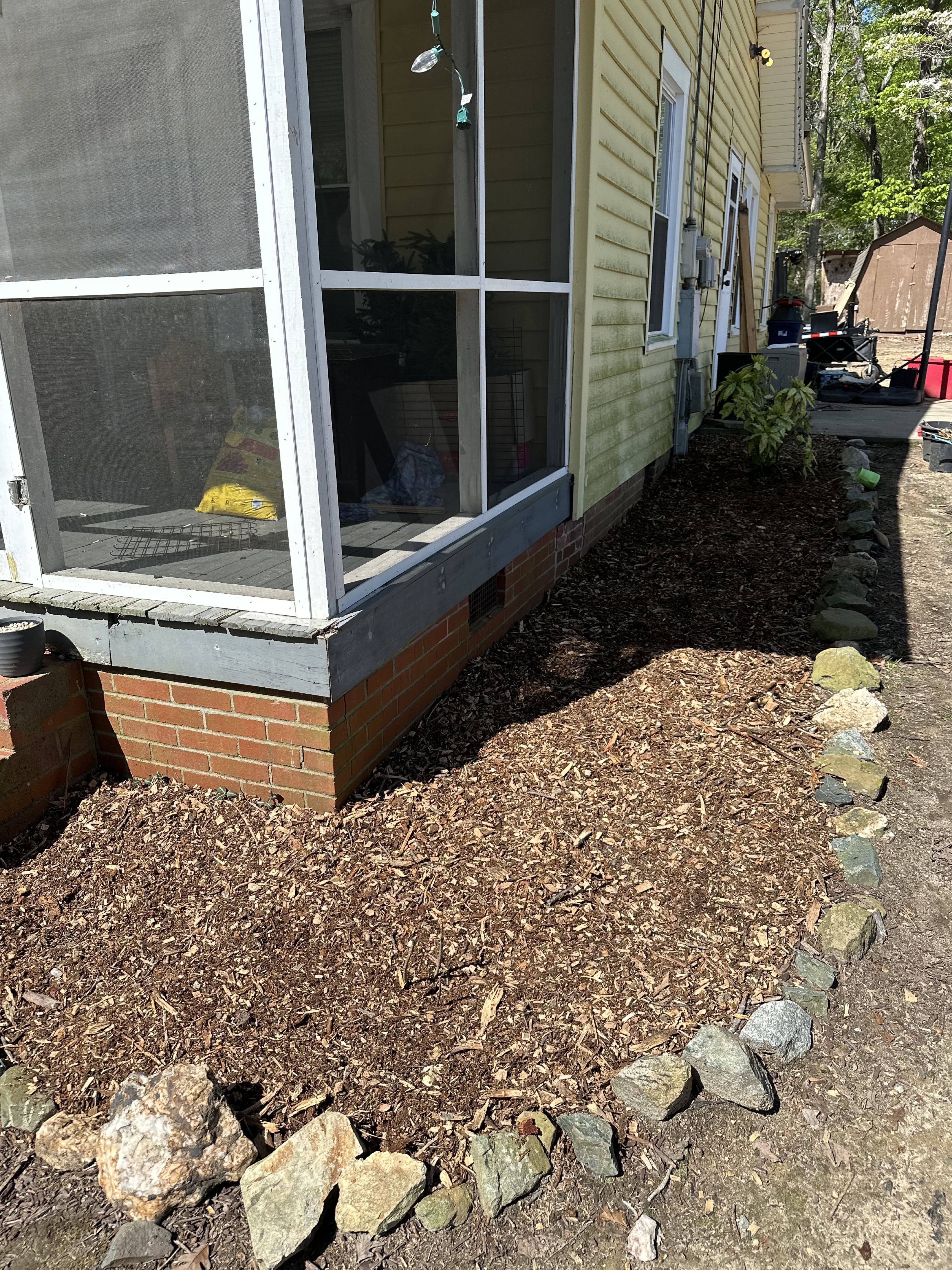 Fresh mulch bed installed around a house